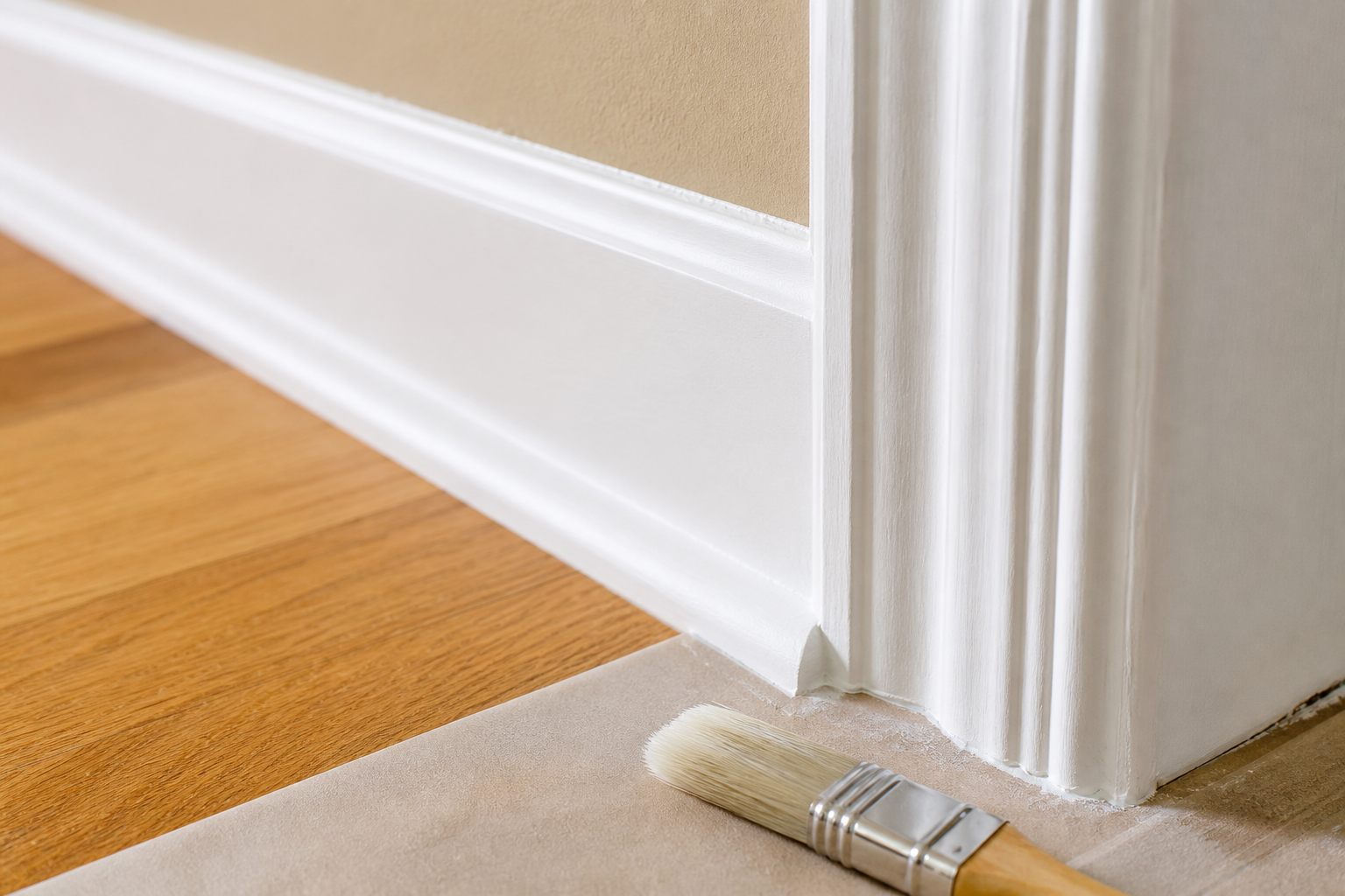 A crisp painted baseboard and doorway trim edge.